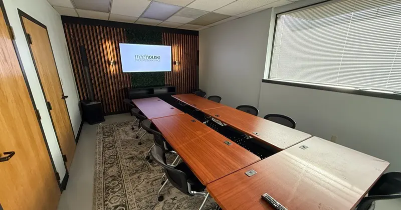 Treehouse meeting room in Colorado Springs — flexible desk setup for creative teams, production meetings, and client sessions